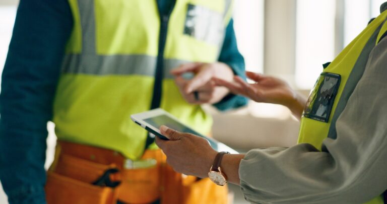 An engineer holding a tablet to study the plan.