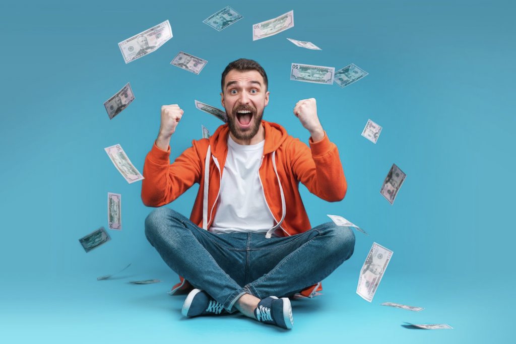 A man cheering while his performance bonus payout flies around him.