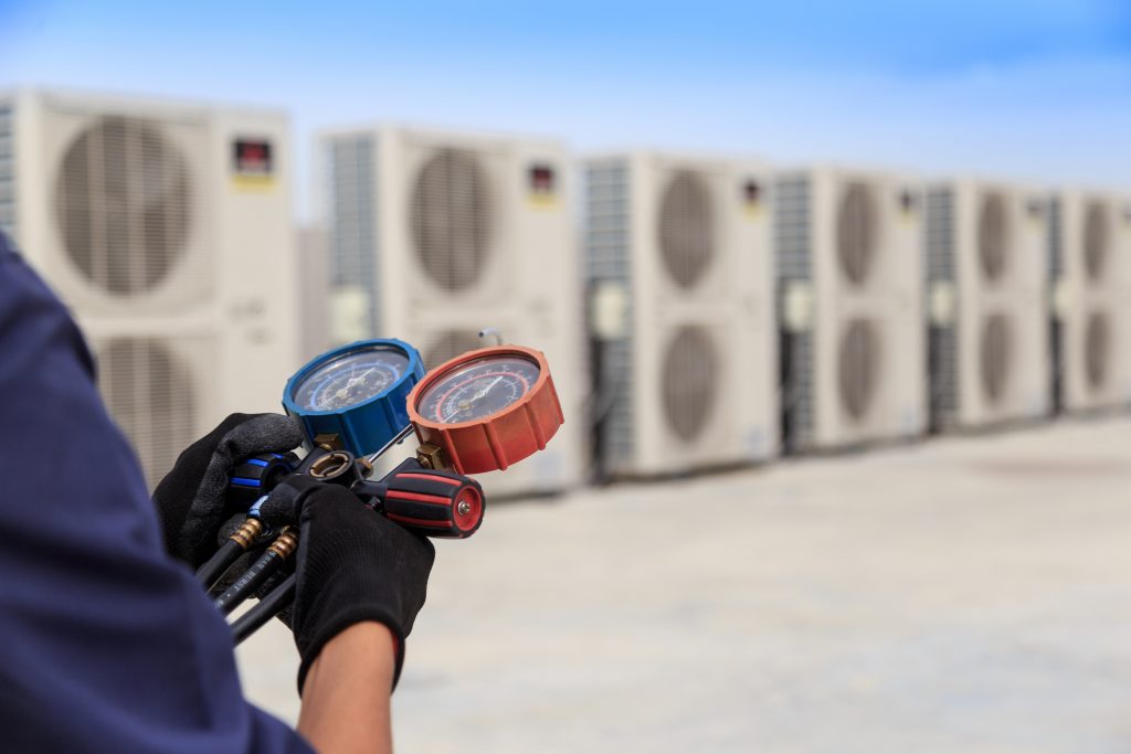 HVAC Technician is checking air conditioner ,measuring equipment for filling air conditioners.