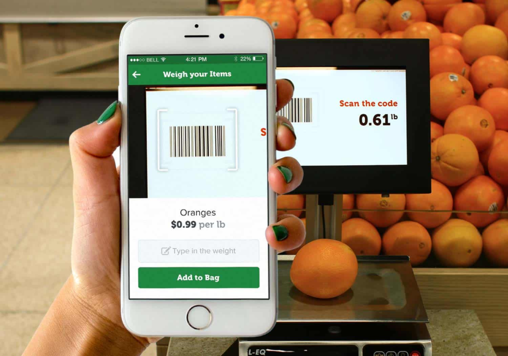 IT retail scan and go being used by customer to buy oranges.