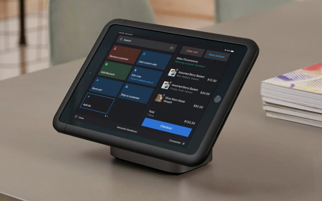 Shopify POS Pro on an iPad with a countertop stand.