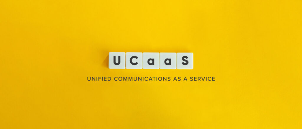UCaaS letters written on wooden blocks with yellow background.
