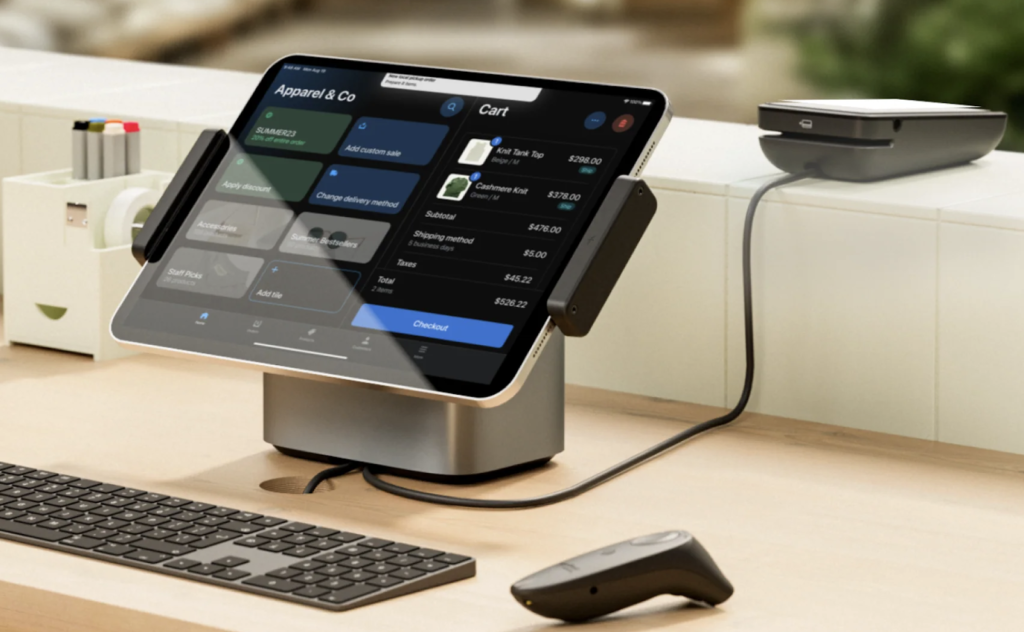 Shopify countertop set up showing tablet stand, POS terminal, wireless barcode scanner and keyborard.