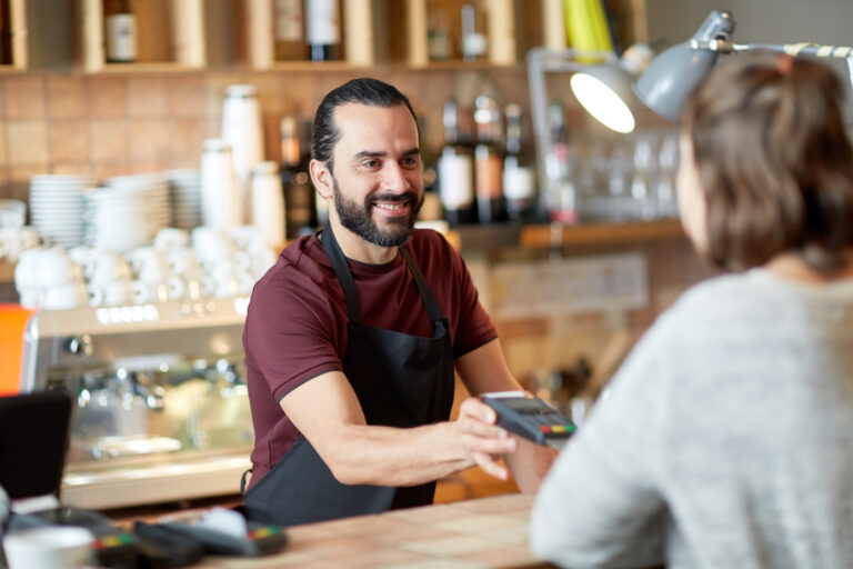 A cashier for restaurant accepting payment through POS.