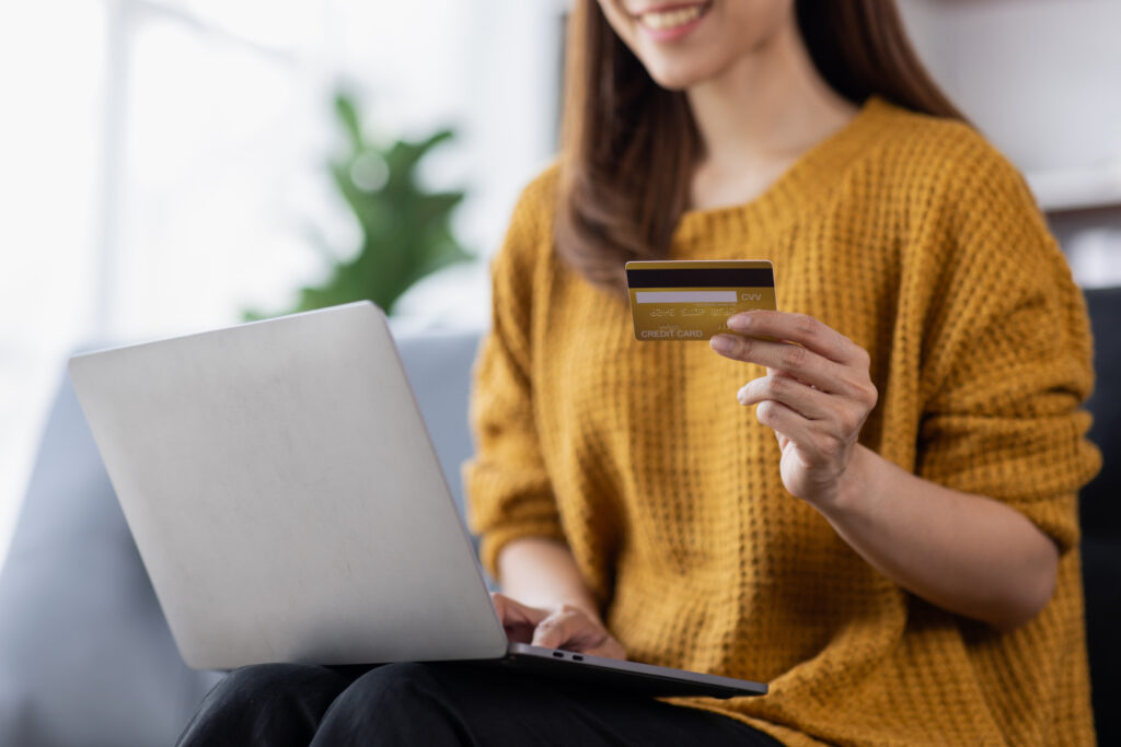 Close up of woman hand using credit card and laptop for payment and online shopping.