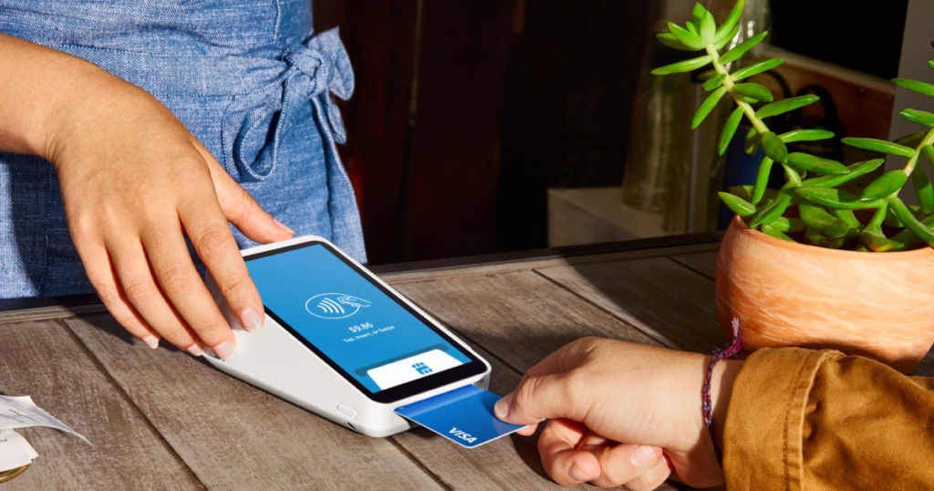 Business owner accepting a card payment with Square Terminal.