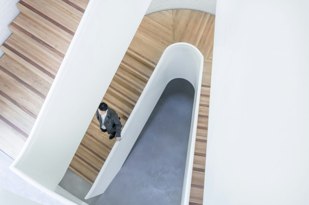 An image of a man walking down a staircase.