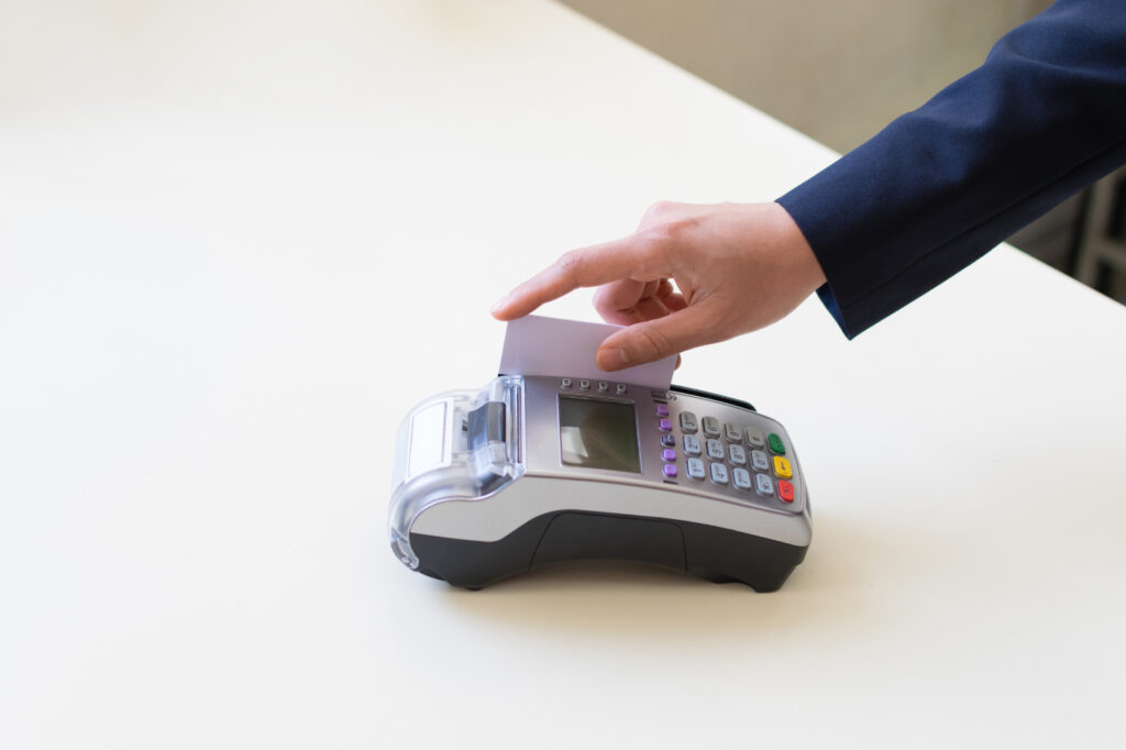 Close Up hand of the man using EDC machine for a credit card.