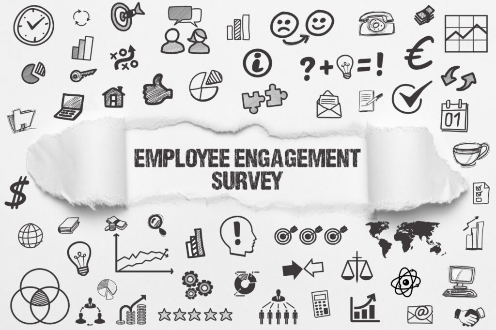 Employee Engagement Survey writeen on white paper with several icons surrounding it.