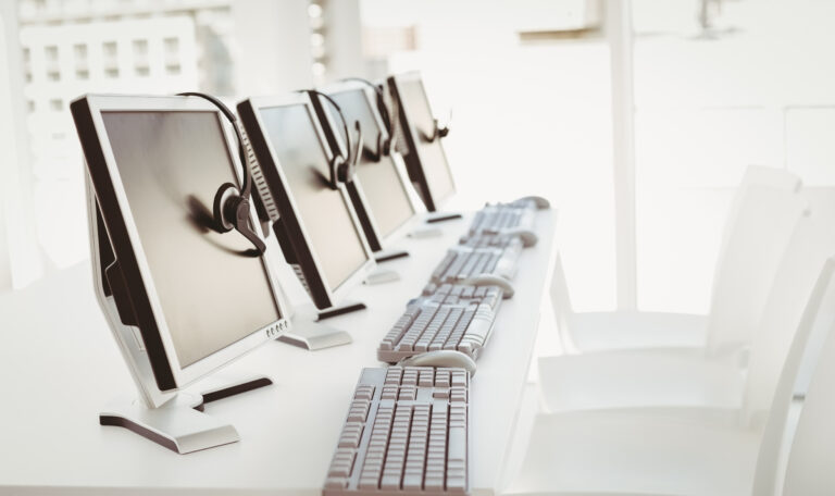 Call center computers and headsets all in a row.