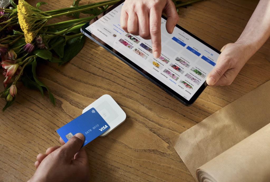 Square POS software on a tablet and a Square mobile card reader.