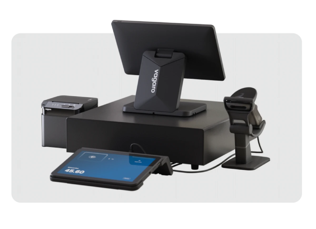 Vagaro PayPro POS set up with tablet stand, customer display, thermal printer, barcode scanner, and cash register.