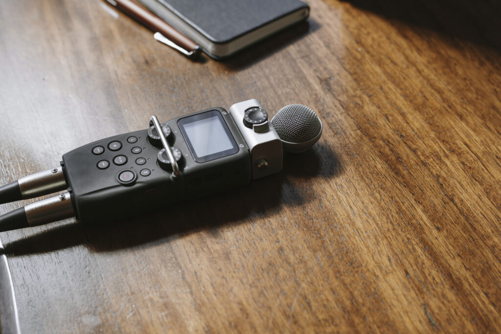 Portable sound recorder on a wooden table.