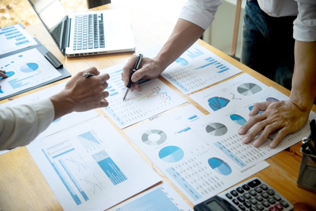 A group of business people analyzing a set of data on a table.