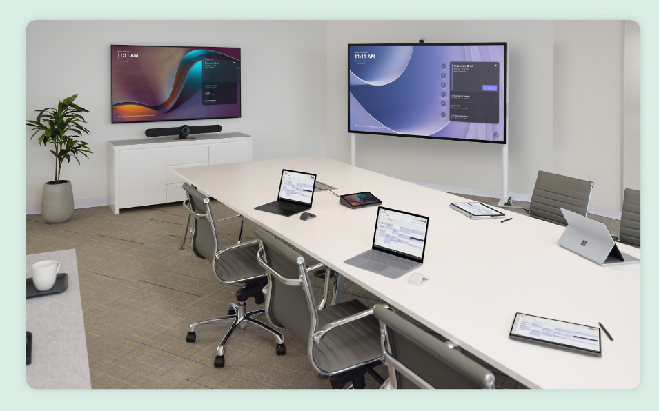 Conference room with Microsoft Teams enabled video conferencing, whiteboards, monitors, laptops, and speakers.