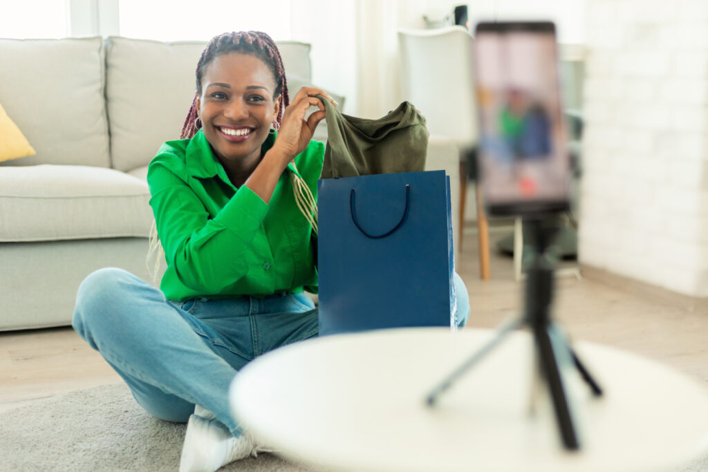 Happy female fashion blogger recording content for her style blog.