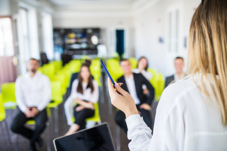 An instructor providing training with employees inside the office.