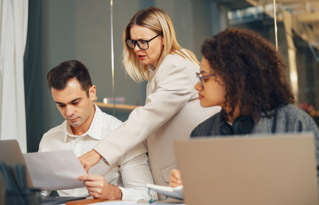 Business team is analysing new financial project while working together on office desk