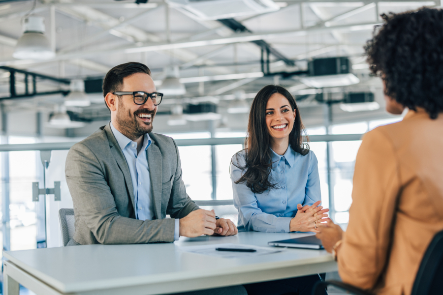 Professional business team conducting an important interview in a modern office setting.