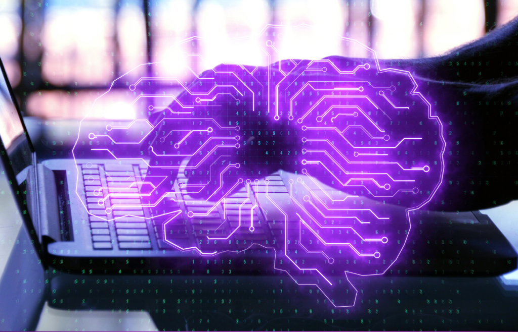 Artificial intelligence AI brain icon glowing over a computer, illustrating digital transformation and future technology.