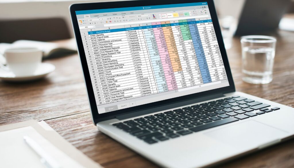 laptop with spreadsheet on screen,