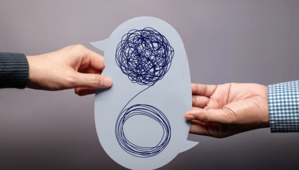 Two people’s hands exchange a speech-bubble-shaped paper showing a tangled scribble transforming into a neat circle, symbolizing turning confusion into clarity or effective communication.