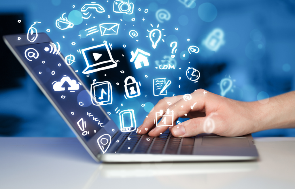 Hand typing on a laptop with glowing social media and digital marketing icons floating above the keyboard.