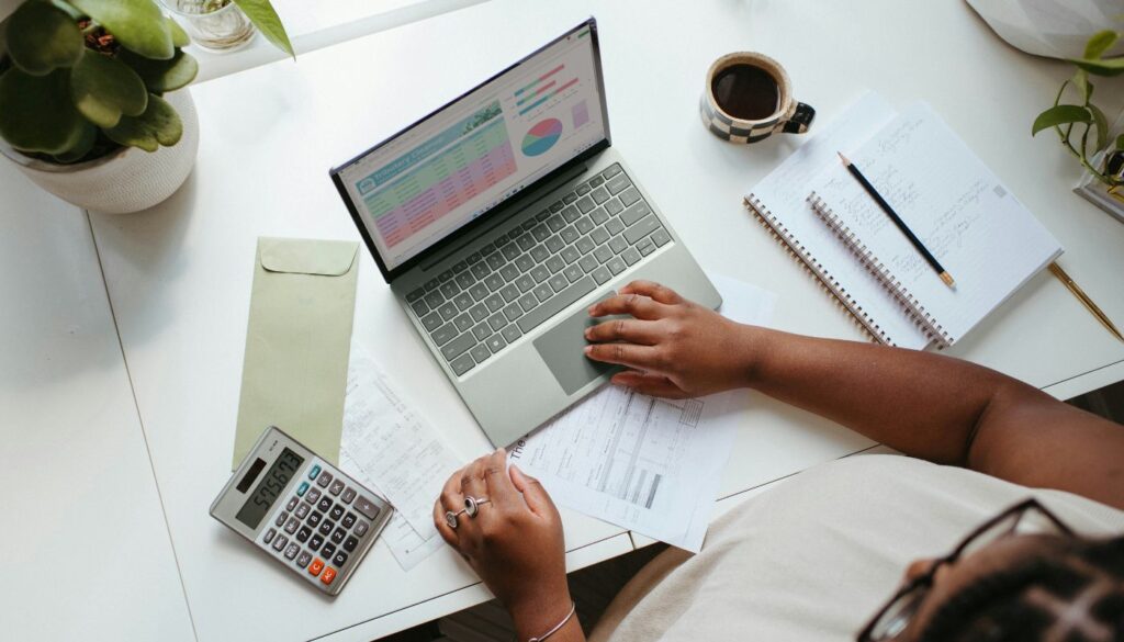 Person sitting at a table with laptop