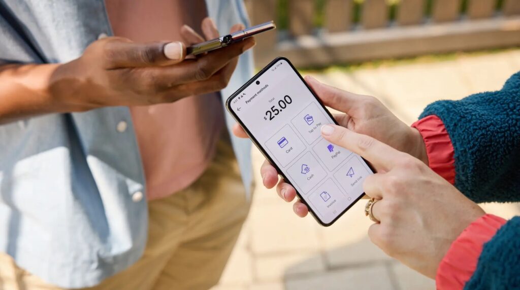 Business owner using the PayPal mobile app to select Tap to Pay for a $25 customer transaction.