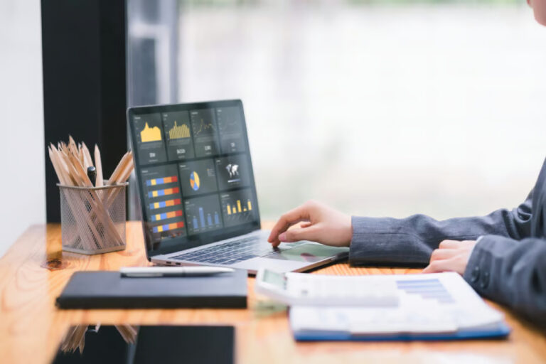 A man checking revenue figures on laptop.